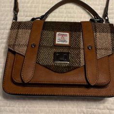 Brown Chestnut Sustainable Microfiber Leather Complemented By Brown Tartan Plaid. It Has A Pair Of Compartments And Decorated With Floral Lining. Clasp Closure At The Front And A Zip Pocket On The Back And Inside For Extra Security. This Bag Can Be Worn Crossbody And It Comes With A Detachable Strap So You Can Also Carry By The Handle. Note: My Purse Is Not Green. That Pic Is To Show The Style. Purchased In St. Augustine, Fl. New Without Tag. Measure Approximately 9.4” Long X 6.3” High X 2.75” W Brown Flap Satchel For Work, Beige Tweed Bags For Everyday Use, Brown Tweed Shoulder Bag For Fall, Brown Tweed Shoulder Bag For Everyday Use, Tweed Top Handle Shoulder Bag For Everyday, Everyday Tweed Top Handle Shoulder Bag, Brown Tweed Bags For Fall, Tweed Satchel Bag For Everyday Use, Everyday Tweed Shoulder Bag With Top Handle