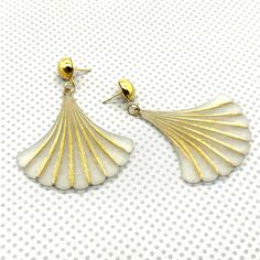 Evoke retro charm with our stunning Gingko Leaf Earrings, featuring a svelte Art Deco scalloped fan design in lustrous lucite. Each drop earring measures 2.75" and is crafted with vintage or vintage-reproduction plastics ethically sourced in Europe. The studs, plated in 18k gold and silver over surgical steel, are perfect for sensitive ears. Available in a variety of colors, these earrings offer a delightful mix of preppy and vintage flair. Large Drop Earrings, Art Deco Fan, Gingko Leaves, Clear Earrings, Lucite Jewelry, Sustainable Brand, Vintage Lucite, Gold And Silver, Guinea Bissau