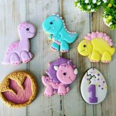 decorated cookies are arranged in the shape of dinosaurs and numbers one - two - three