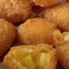 some fried food is on a red and white checkered table cloth