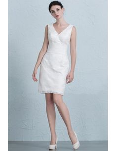 a woman in a white dress is posing for the camera