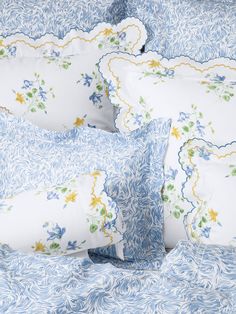 blue and white floral bedding with scalloped edges, pillows and pillow cases