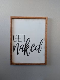 a sign that says get naked hanging on the wall