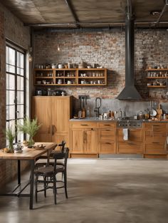 an industrial style kitchen with brick walls and wooden cabinets is pictured in this image, there are several chairs around the table