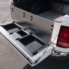 the back end of a white truck with its trunk open