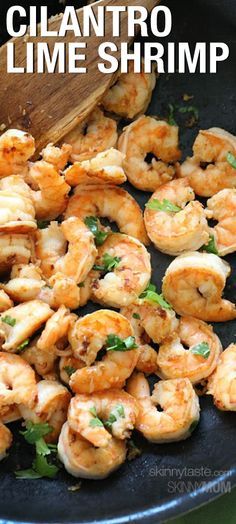 a skillet filled with shrimp and garnished with parsley