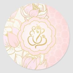 a pink and gold floral sticker with the letter e on it's center