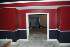 an empty room with red, white and blue walls