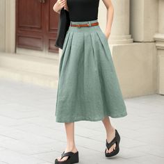 "This charming linen skirt in a muted green shade offers a fresh take on a classic A-line silhouette. The high waist is beautifully defined by pleats, creating a flattering shape that adds both volume and movement. The skirt's length is perfect, hitting just below the knees, making it versatile for various occasions.  DETAIL * 50% linen, 50% cotton * Two seam pockets * Belt loops * Right zipper closure * No lining in side * Wash by hand or machine with cold water * Belt is not sale items * The model is 170cm (5′7″) tall with a 80cm (31.5\") bust, 66cm (26\") waist. She is wearing the Khaki skirt in size XS. * Choose CUSTOM Order if you    Can't find your size in our size Chart    Chang the Length    Your Height is not Between 5'1\" - 5\"9\"    Your weight is not Between 45kg - 75kg SIZE GU Pleated Linen Long Skirt, Pleated Full Linen Skirt, Pleated Flowy Linen Skirt, Green Knee-length Pleated Skirt For Summer, Pleated Linen Flared Skirt, Full Linen Maxi Skirt For Spring, Solid Linen Summer Skirt, Solid Linen Skirt For Summer, Solid Long Linen Skirt