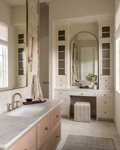 a large bathroom with two sinks and mirrors