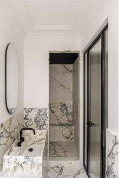 a bathroom with marble floors and walls