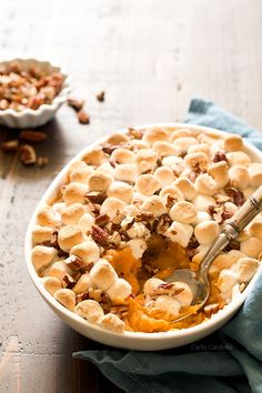 a bowl filled with dessert sitting on top of a wooden table