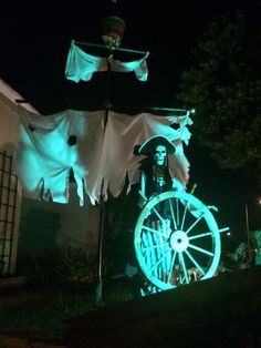 an image of a person on a spinning wheel in the dark with green light coming from behind it