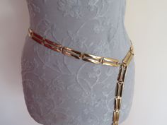 "Fabulous vintage high end gold tone belt dating from the 1990's Consists of a panel of rectangular plates with cut out centre design The belt fastens with a lobster claw catch into the gold tone extender chain with ball weight at the end. The rectangular link panel measures approx 40\" length x 0.75\" width The gold tone extender chain measures approx 6\" Fully adjustable so could be worn round the waist or lower down on the hips. In excellent vintage condition - see photos Postage in the UK is Gold Rectangular Belt For Formal Occasions, Vintage Chain Belt, Gold Elegant Belt, Gold Rectangular Elegant Belt, Elegant Gold Rectangular Belt, Vintage Chain, Gold Belts, Chain Belt, Wow Factor