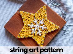 a string art star on a wooden board