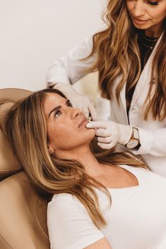 a woman getting her teeth checked by a dentist