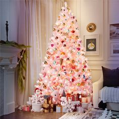 a pink christmas tree with presents under it