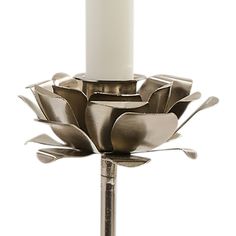 a candle is sitting on top of a metal flower