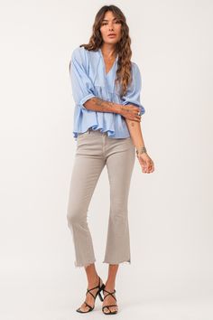 image of a female model wearing a MALIA V-NECK TOP ICE BLUE DEAR JOHN DENIM Spring Tops With Frayed Hem For Casual Gatherings, Effortless V-neck Blouse For Spring, Casual Cotton V-neck Blouse, Cotton V-neck Blouse For Casual Gatherings, Light Wash V-neck Blouse For Spring, Dear John, V Neck Tops, Ice Blue, Relaxed Fit