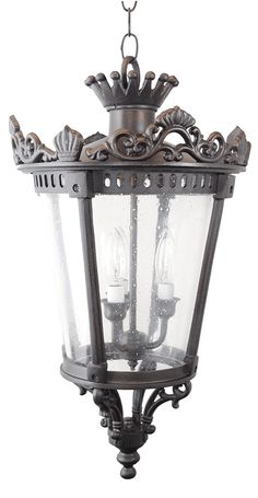 an old fashioned hanging light fixture with two lights on each side and one light in the middle