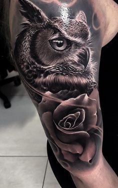 an owl with a rose tattoo on the left arm and half - sleeved body