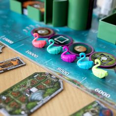 a board game with flamingos and other items on it