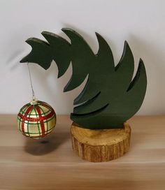 an ornament with a pineapple on it next to a tree stump