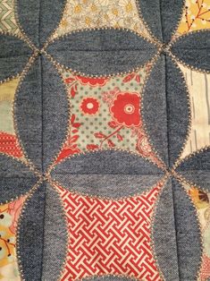 a patchwork quilt with many different designs on it