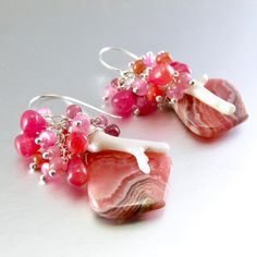 I love these focals! They are Argentine rhodochrosite gems and measure 22x20mm. They have been wrapped in sterling silver wire and dangle below a gorgeous combination of smooth ruby briolettes, pink moonstone, pink sapphire, white branch coral. Each bead is meticulously wrapped onto it's own head pin. The entire cluster is topped. I have used simple sterling ear wires. The earrings measure 1 3/4 (44mm.) from the top of the ear wires. Sterling Silver Pink Wire Wrapped Earrings, Pink Sterling Silver Wire Wrapped Earrings, Unique Pink Gemstone Earrings, Unique Pink Sterling Silver Earrings, Pink Natural Stones Gemstones In Sterling Silver, Pink Gemstones For Gifts, Unique Pink Gemstones For Gifts, Black Freshwater Pearls, Pink Moonstone