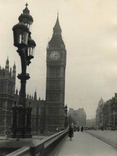 the big ben clock tower towering over the city of london, england in black and white