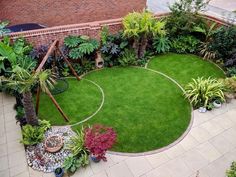 an aerial view of a garden with green grass and plants in the center, surrounded by brick walls