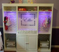 a baby's room with purple lights and chevron wallpaper