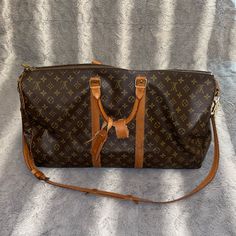 Update 3/24/24: Both Rivets Have Been Replaced And The Bag Has Been Stitched Up By Louis Vuitton!! Comes With Box & Dust Bag. Update 1/11/24: Bag Has Been Shipped To Louis Vuitton To Have Both Rivets (Screws) Replaced!! Will Update Once It Has Been Returned. Beautiful Duffel Bag With Strap, Sad To Let Her Go, Size Is Carry On Approved Screw & Screw Cap On One Of The Handles Is Loose Causing It To Separate (Picture 5) Screw Cap On Strap Holder Is Missing Causing It To Separate; Not A Big Deal To Me But Both Can Be Taken And Fixed :) (Picture 8) Minor Scuffs Due To Normal Wear, Please Review All Pictures Thoroughly! I Also Purchased The Red Insert For The Bag To Avoid Any “Drooping” Louis Vuitton Keepall, Let Her Go, Screw Caps, Big Deal, Duffel Bag, Rivets, Travel Bags, Louis Vuitton Monogram, Louis Vuitton Bag