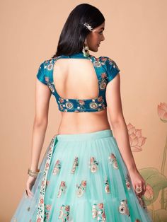 Wrapped up in the warmth of comfort and style, this pleasant sky blue color lehenga is formed with net material designed with mirror work, thread embroidery, and sequin work. This sky blue lehenga arrives with a sky blue color art silk material choli made with embroidery and mirror work. It also comes with a blue color net material dupatta created with thread embroidery and sequin work. This sky-blue lehenga is stitched and can be customized up to 42 inches. The choli will be fully stitched mate Fitted Net Lehenga With Intricate Embroidery, Fitted Lehenga With Intricate Embroidery In Net, Fitted Net Choli With Intricate Embroidery, Fitted Blue Sharara With Floral Embroidery, Floor-length Fitted Choli With Floral Embroidery, Fitted Blue Choli With Intricate Embroidery, Fitted Floor-length Choli With Floral Embroidery, Fitted Blue Lehenga With Intricate Embroidery, Blue Bollywood Lehenga With Floral Embroidery