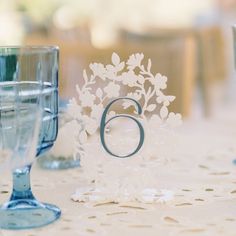 the table is set with glasses and place settings for an elegant wedding breakfast or reception