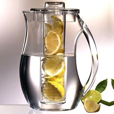 the pitcher is filled with lemons and water