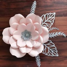 a paper flower on a wooden table