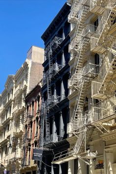 several fire escapes are on the side of an apartment building