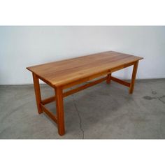 a wooden table sitting on top of a cement floor