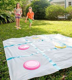 Tic Tac Toss: Take the game of Xs and Os outside -- and into the air -- with this supersize version. On a flat surface, adhere strips of duct tape to a shower curtain liner, as shown. Use more tape to make Xs on four flying disks or heavyweight plastic plates. You'll need four more disks or plates for Os. To play, set up a throw line, then follow the rules of tic-tac-toe. If your disk lands off the board, in an already-claimed square, or centered on a line, throw it again. For a more challenging Summer Outdoor Games, Outside Games, Fun Outdoor Games, Outdoor Birthday, Outdoor Games For Kids, Yard Games, Backyard Games, Carnival Games, Camping Games