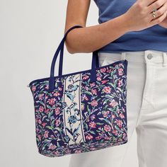 This coated-canvas tote is the perfect companion from work day to weekend. Toss in your necessities (with room for extras!) and take on the day! 100% cotton with polyurethane coating and trim Interior features a hanging slip pocket Zip closure. Dimensions: 10. 5" w x 10. 0" h x 4. 0" d Handle/Strap Strap drop 6. 75" removable strap 39. 0" Trim Material : Faux Leather Vera Bradley Outlet Small Every Day Tote Bag in Perennially Cream | 100% Cotton Fashion Umbrella, Work Backpack, Weekend Travel Bags, Medium Backpack, Belt Purse, Flip Flop Slippers, Toiletry Bag Travel, Small Backpack, Large Backpack