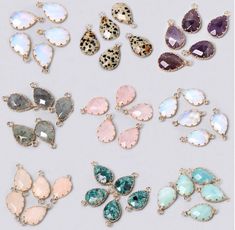 several pairs of earrings with different shapes and colors