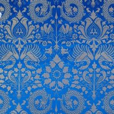 a blue and silver wallpaper with an intricate design on it's side,