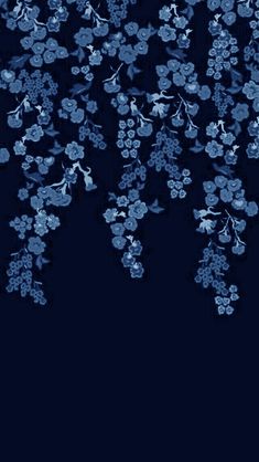 blue flowers are flying in the air on a black background