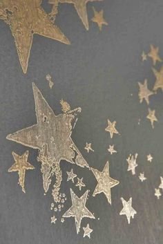 some gold stars on a black surface