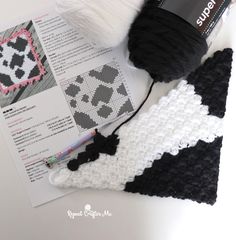 a crochet pattern next to a yarn ball and knitting needles on top of a piece of paper