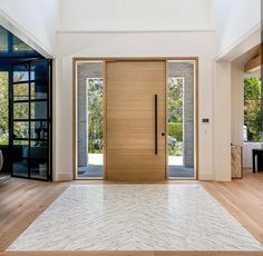 an empty room with wooden doors and white tile on the floor is pictured in this image