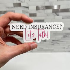 someone holding up a sticker that says need insurance? it's talk