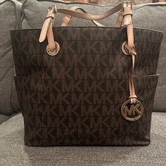 Brown And Tan Michael Kors Large Logo Tote Large Sized Bag; 14-3/4"W 11"H 6-1/4"D (Width Is Measured Across The Bottom Of Handbag) 2.22 Ibs. Approx. Weight 8-1/2"L Handles Open Top Zipper Middle Storage Bags Michael Kors, Open Top, Large Tote, Michael Kors Bag, Handles, Michael Kors, Bag Lady, Zipper, Handbags