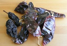 several dried peppers on a wooden table